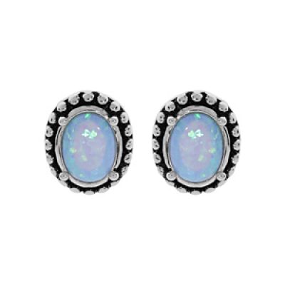 Boucles d'oreille en argent rhodié Opale bleue de synthèse cerclée de picot patiné et fermoir poussette